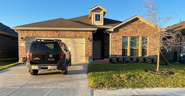 view of front of property featuring a garage and a front lawn