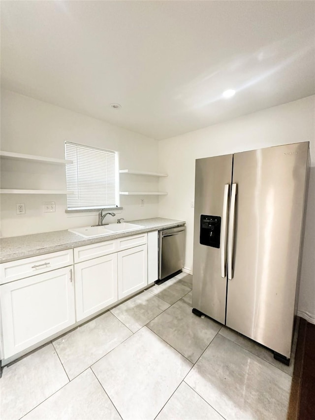 729 N Ruddell St, Denton, TX 76209 - kitchen featuring open shelves, appliances with stainless steel finishes, a sink, white cabinetry, and light countertops
