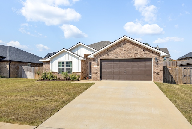 view of front of house featuring a front yard and a garage