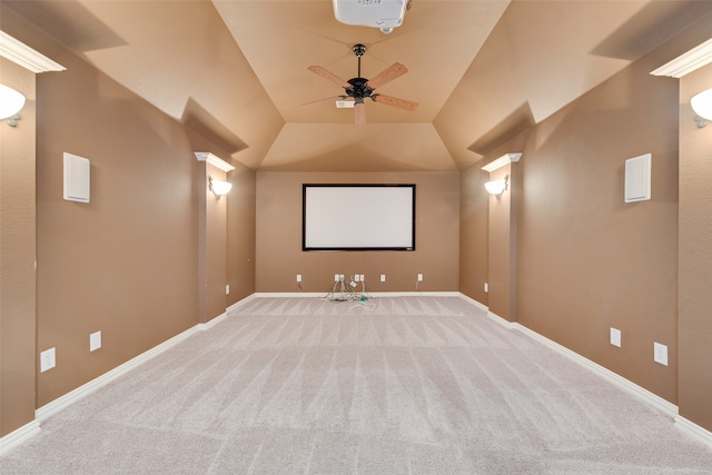 carpeted home theater room with ceiling fan and lofted ceiling