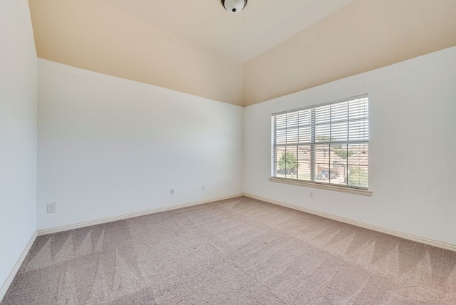 empty room featuring carpet floors and lofted ceiling