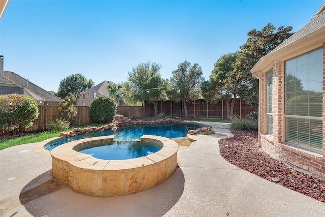 view of pool featuring an in ground hot tub and a patio area