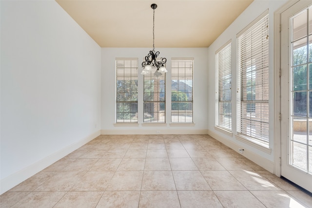 unfurnished dining area featuring light tile patterned flooring and a chandelier