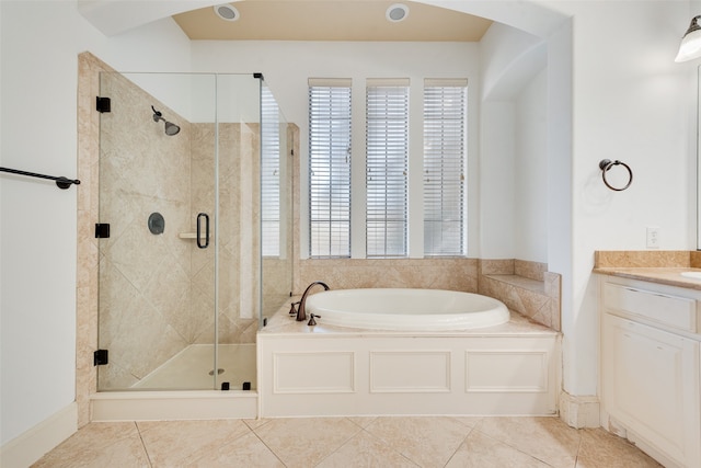 bathroom with vanity, plus walk in shower, and tile patterned flooring