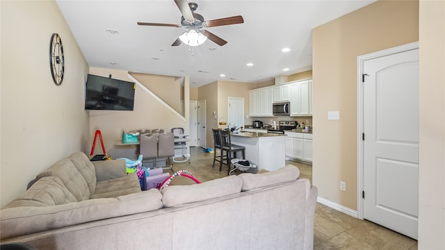 living room with light tile patterned floors and ceiling fan