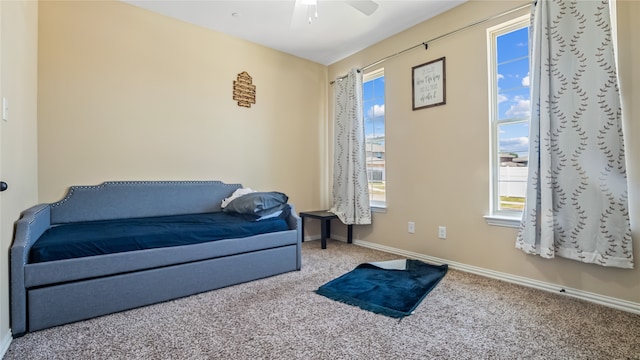 living area featuring carpet floors and ceiling fan