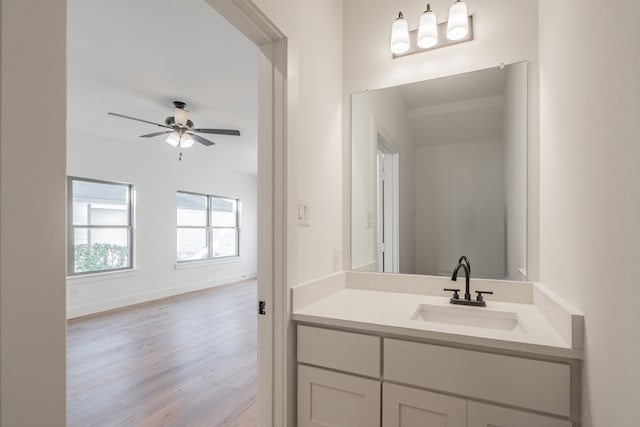 bathroom featuring vanity, hardwood / wood-style floors, and ceiling fan