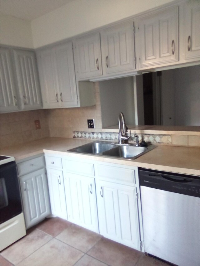 kitchen featuring dishwasher, white range, sink, tasteful backsplash, and white cabinetry