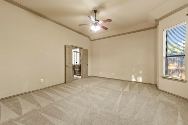 carpeted empty room with crown molding, ceiling fan, and vaulted ceiling