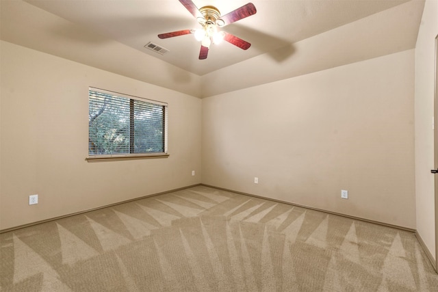 carpeted spare room with ceiling fan