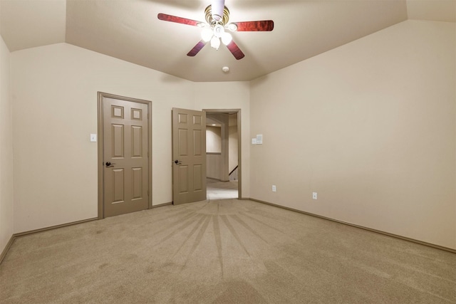 unfurnished bedroom with ceiling fan, carpet floors, and lofted ceiling