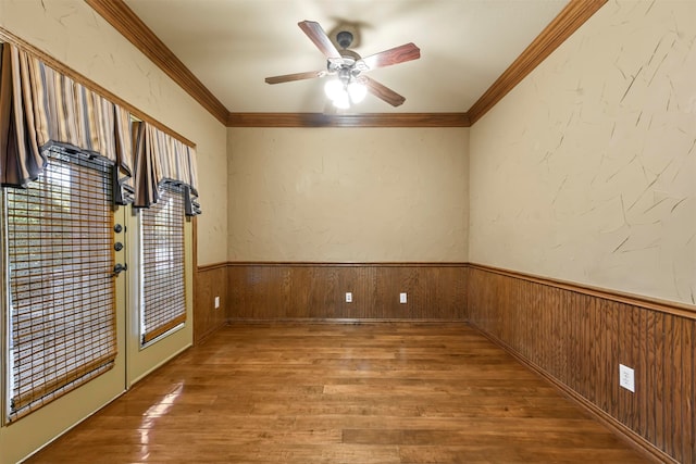 unfurnished room featuring ornamental molding, hardwood / wood-style flooring, and ceiling fan