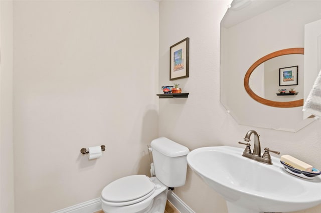 bathroom featuring sink and toilet