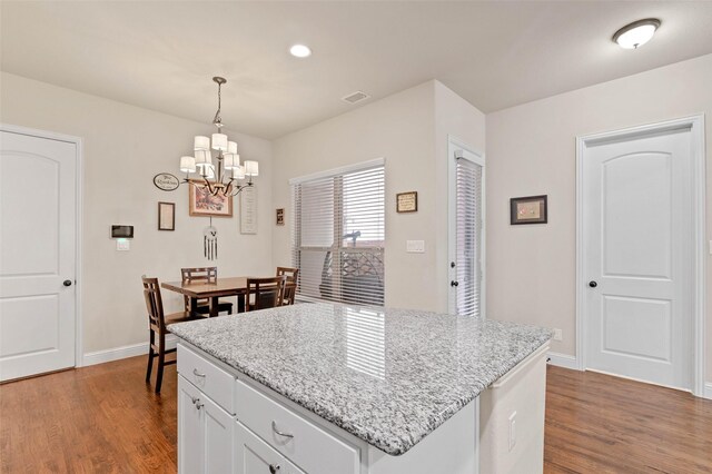 kitchen with a center island, sink, appliances with stainless steel finishes, and dark wood-type flooring