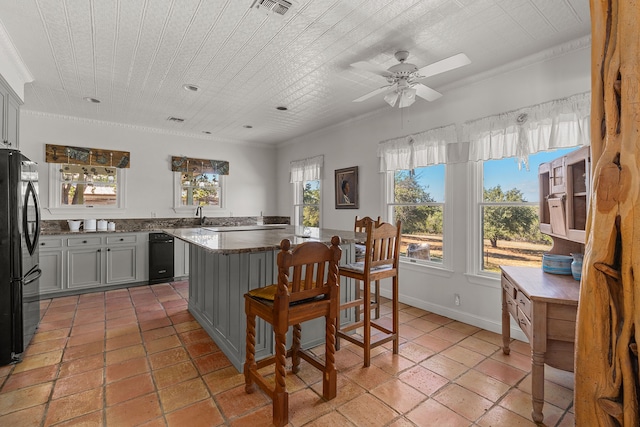 kitchen with crown molding, gray cabinets, ceiling fan, and black fridge