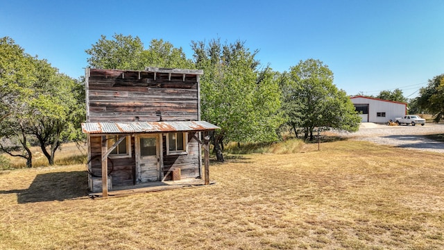 view of outbuilding with a yard