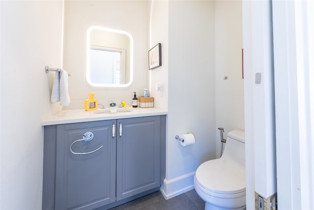 bathroom with vanity, toilet, and tile patterned floors