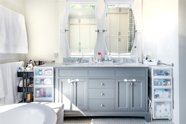 bathroom with vanity, tile patterned flooring, and a bath