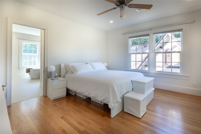 bedroom featuring multiple windows, light wood-type flooring, and ceiling fan