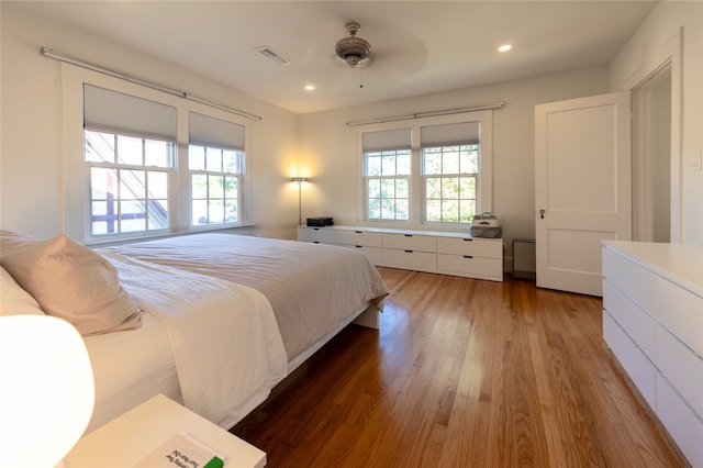 bedroom with ceiling fan and dark hardwood / wood-style flooring