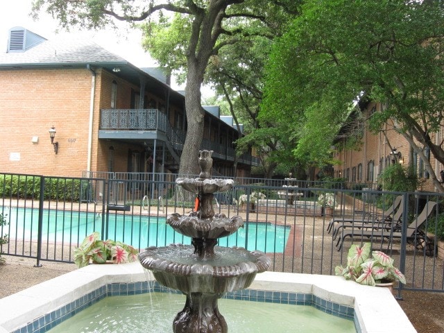 view of swimming pool featuring a hot tub