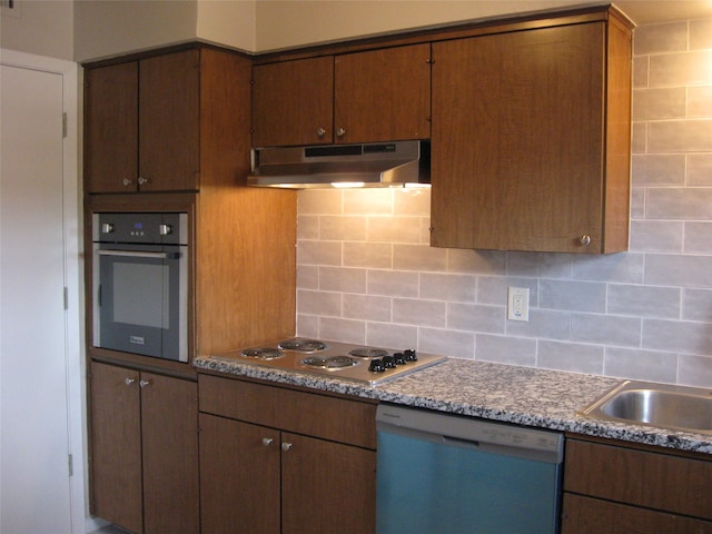 kitchen with white appliances and decorative backsplash