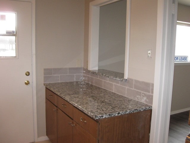 bathroom with decorative backsplash, wood-type flooring, and vanity