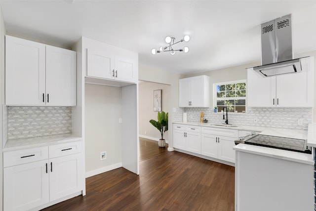 kitchen with tasteful backsplash, extractor fan, white cabinetry, dark hardwood / wood-style floors, and sink