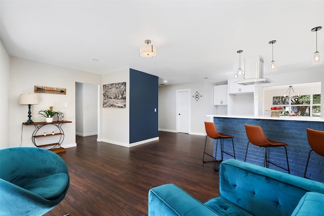 living room featuring indoor bar and dark wood-type flooring