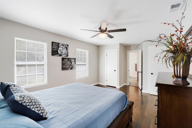 bedroom with dark hardwood / wood-style flooring and ceiling fan