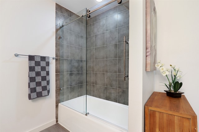 bathroom with combined bath / shower with glass door and wood-type flooring