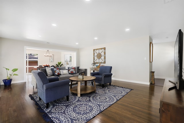 living room featuring a chandelier and dark hardwood / wood-style flooring