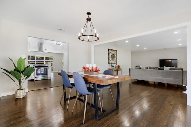 dining room with an inviting chandelier and dark hardwood / wood-style flooring