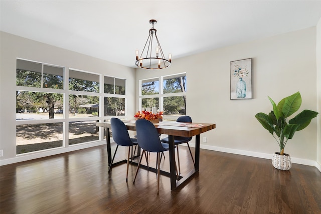 dining space featuring a notable chandelier and dark hardwood / wood-style flooring