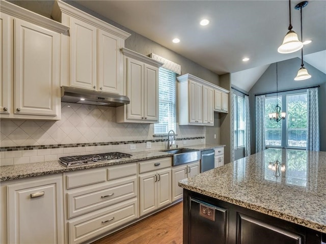 kitchen with a healthy amount of sunlight, sink, an inviting chandelier, and appliances with stainless steel finishes