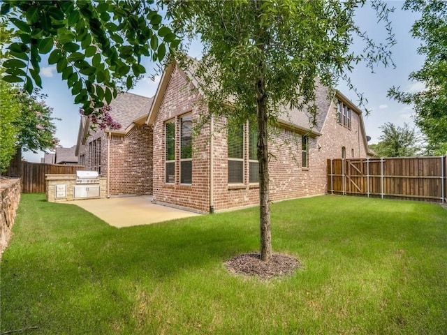 back of property featuring a patio and a yard