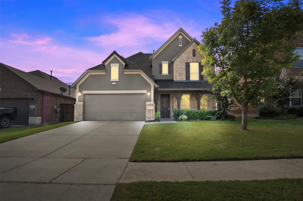 view of front of home featuring a lawn and a garage