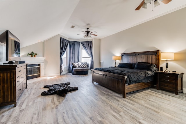 bedroom with ceiling fan, light hardwood / wood-style flooring, crown molding, and lofted ceiling