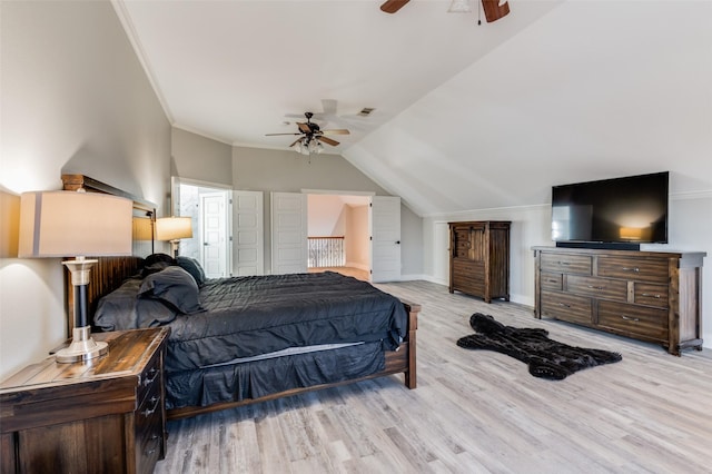 bedroom with ceiling fan, light hardwood / wood-style flooring, and lofted ceiling