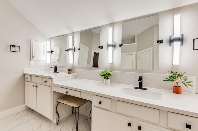 bathroom with vanity and lofted ceiling