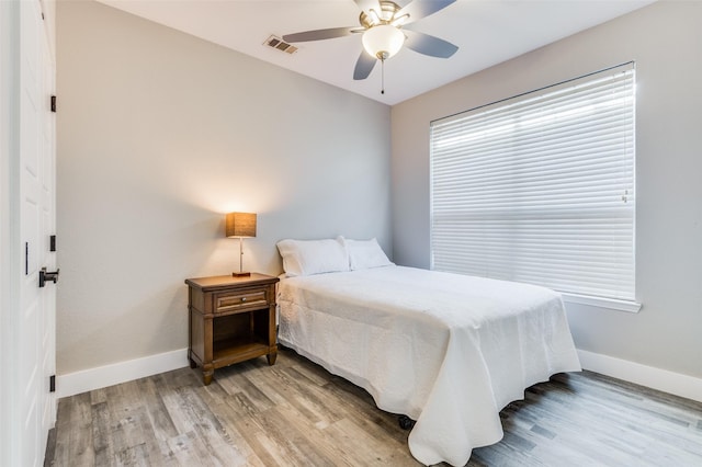 bedroom with ceiling fan and light hardwood / wood-style flooring