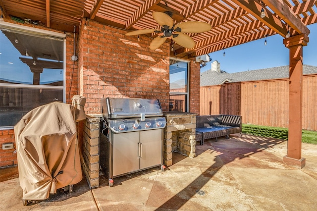 view of patio / terrace featuring a pergola, an outdoor kitchen, ceiling fan, and a grill