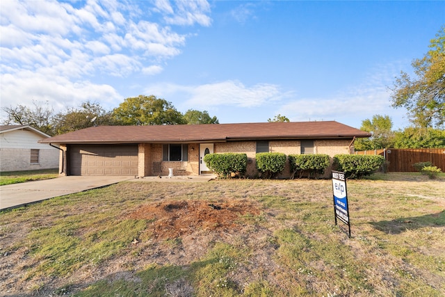 single story home with a garage and a front lawn