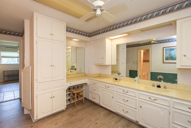 bathroom with hardwood / wood-style flooring, ceiling fan, and vanity