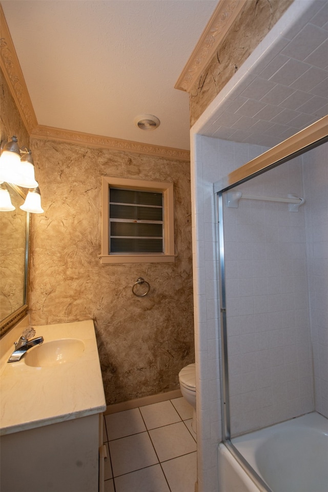 full bathroom featuring tile patterned floors, shower / bath combination with glass door, vanity, and toilet