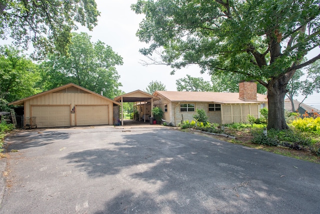 ranch-style house with a carport and a garage