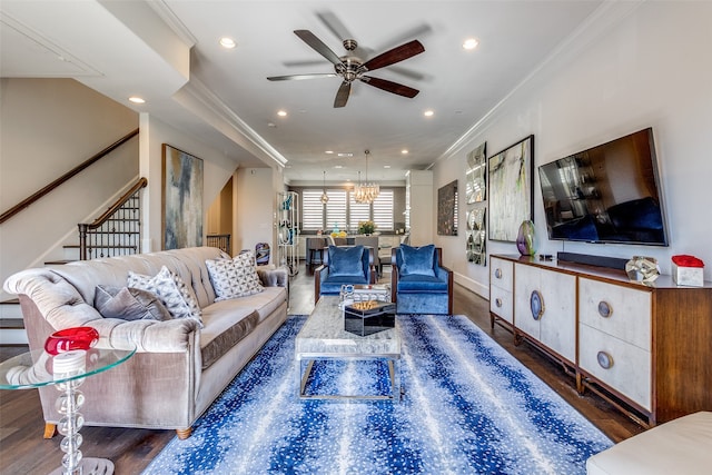 living room featuring ornamental molding, dark hardwood / wood-style floors, and ceiling fan with notable chandelier