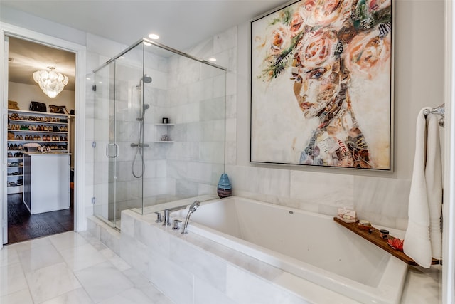 bathroom featuring a notable chandelier, independent shower and bath, and hardwood / wood-style floors