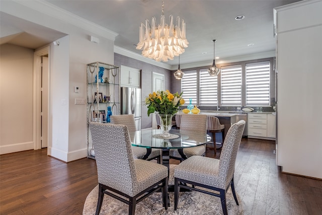 dining space featuring crown molding, a chandelier, and dark hardwood / wood-style flooring