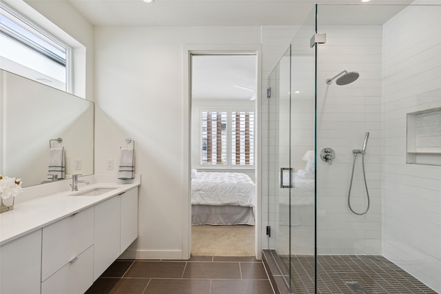 bathroom featuring tile patterned floors, an enclosed shower, a wealth of natural light, and vanity